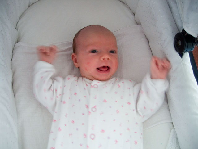 Jessica happy in her cot