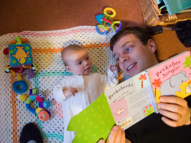 Jessica reads a book to Daddy