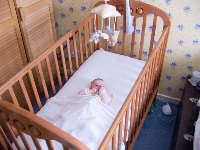 Looking very small the first night in a cot