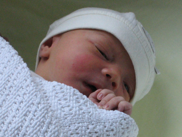 Jessica in her cot beside Heidi's hospital bed