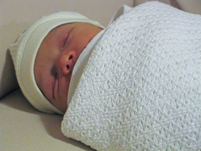 Jessica reclines on the family sofa